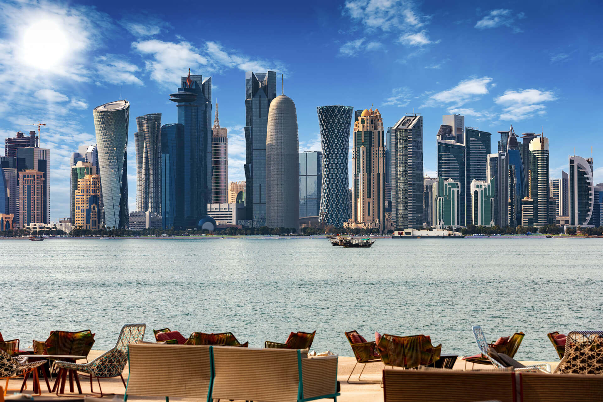 The skyline of Doha in Qatar with chairs and tables in front